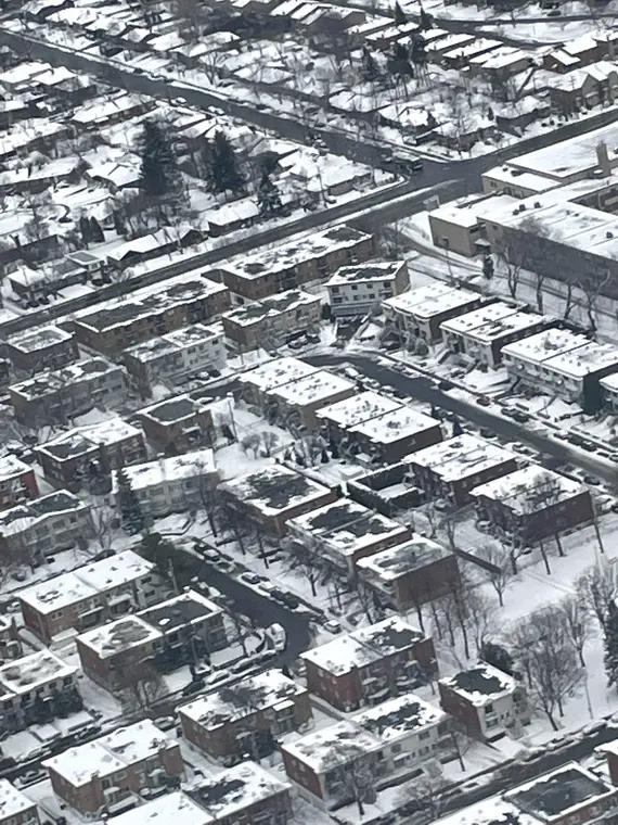 Aerial view of a snow-covered city neighborhood